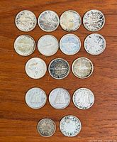 Front view of all coins laid out on wood surface