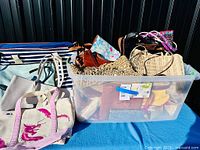 Overall view of bin filled with assorted handbags and totes