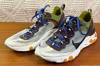 Lateral view of both shoes showing translucent upper and React midsole