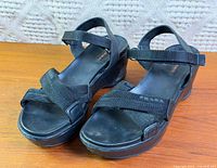 Full view of the pair of black Prada platform sandals