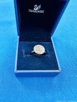 Ring in open Swarovski box showing pavé crystal face