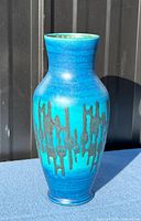 Front view of blue glaze vase showing drip pattern