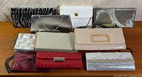 Group shot of all ten clutch purses on table