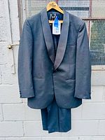 full view of jacket and trousers on hanger