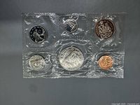 Front view of sealed 6-coin set showing reverse designs