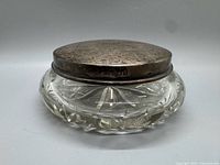 Full view of jar showing cut crystal body and silver lid