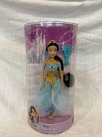 Front view of sealed Disney Parks Jasmine doll in clear tube