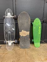 Front view of three skateboards standing upright