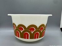 Side view showing full Arches pattern band on white opal glass bowl