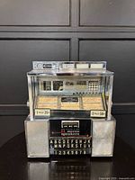 Front view of Seeburg SC-1 wallbox showing coin slots, keypad, speakers