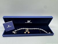 Open Swarovski box showing bracelet, earrings, booklet