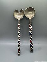 Front view of metal spoon and fork showing full length and bead pattern