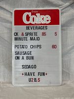 Front view of Coca-Cola menu board with letters inserted
