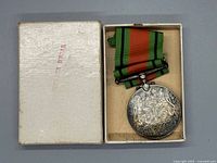 Medal in open presentation box showing ribbon and obverse detail