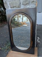 Full view of mirror front showing frame colors and oval glass