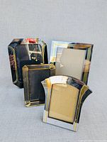 Four art deco style metal photo frames standing together