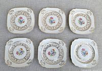 Six matching Harker Pottery dessert plates displayed front side