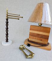 Full view of towel holder, lamp with shade, and door knocker