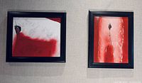 Both framed paintings side by side on wall