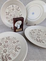 Group shot of four plates and squirrel plaque