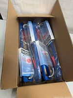 Four individually packaged Hardwater Tackle HTU-200 tip-ups inside the original shipping carton