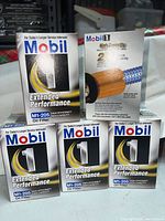Group shot of five boxed Mobil 1 M1-205 oil filters