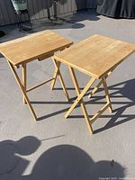 Both pine folding TV tables unfolded on patio
