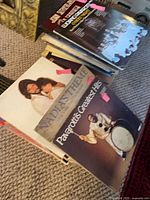 Stack of vinyl records showing "Nadia's Theme" and "Pavarotti's Greatest Hits" sleeves