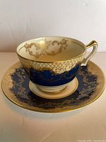 Cup on saucer showing cobalt band and gold gilt