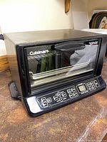 Front view of Cuisinart convection toaster oven broiler showing brand name and Exact Heat label