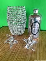 Group shot of rhinestone hurricane vase, mercury glass bottle and two star candle holders