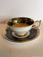 Teacup on saucer showing cobalt blue and gold gilt design