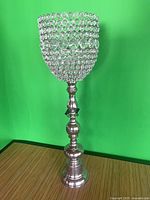 Full view of tall silver candlestick with crystal-bead cup