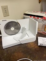 Front view of Tefal slicer showing blade, food carriage, power cord