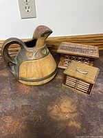 Group shot showing pottery pitcher, trinket box, and coaster holder