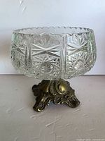 Full view of crystal bowl on ornate metal base