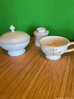 All three ceramic pieces together: lidded soup tureen, butter crock, footed mug