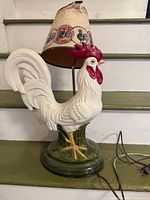 Full view of ceramic rooster lamp with shade and cord