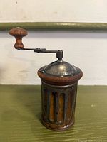 Full view of Peugeot wooden cylindrical coffee grinder with crank