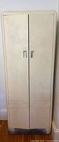 Full front view of cream metal cabinet