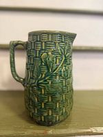 Full side view of green basketweave pitcher