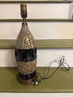 Full view of ceramic lamp showing shape, glaze pattern, cord