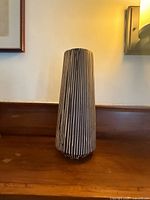 Full front view of striped ceramic vase