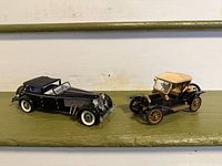 Front three-quarter view of both model cars