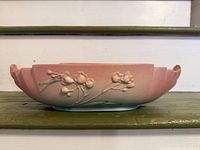 Side profile of bowl showing apple blossom relief and glaze gradient