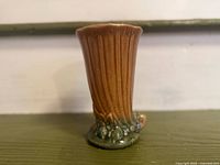 Full view of vase showing fluted sides and base motif