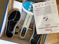 AccuRelief foot circulator device in box with remote and Sunny manual visible