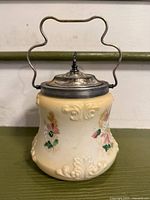 Full view of biscuit jar showing floral design and lid