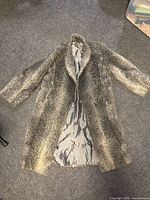 Full view of coat opened to show lining and overall length