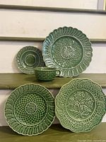 All five green ceramic pieces displayed